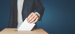 stock-photo-man-voter-putting-ballot-into-voting-box-democracy-freedom-concept-near-blue-wall-copy-space-797688190.jpg
